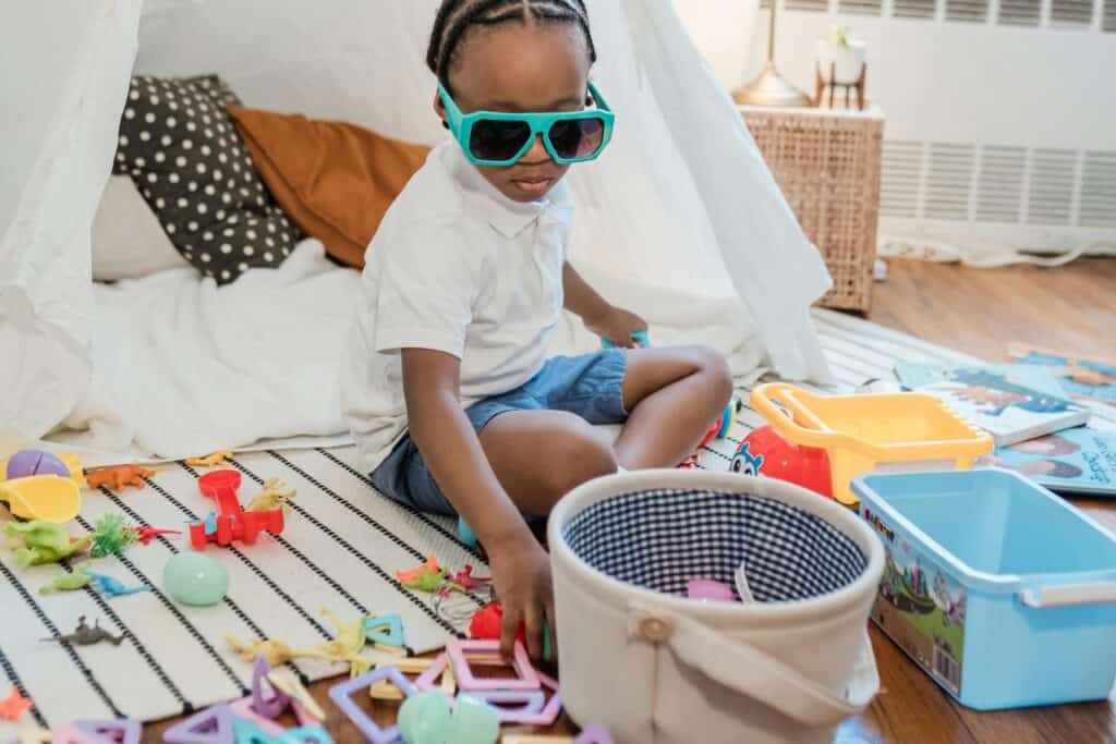A boy picking toys to keep and donate