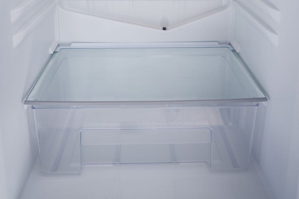 Closeup of an opened empty refrigerator