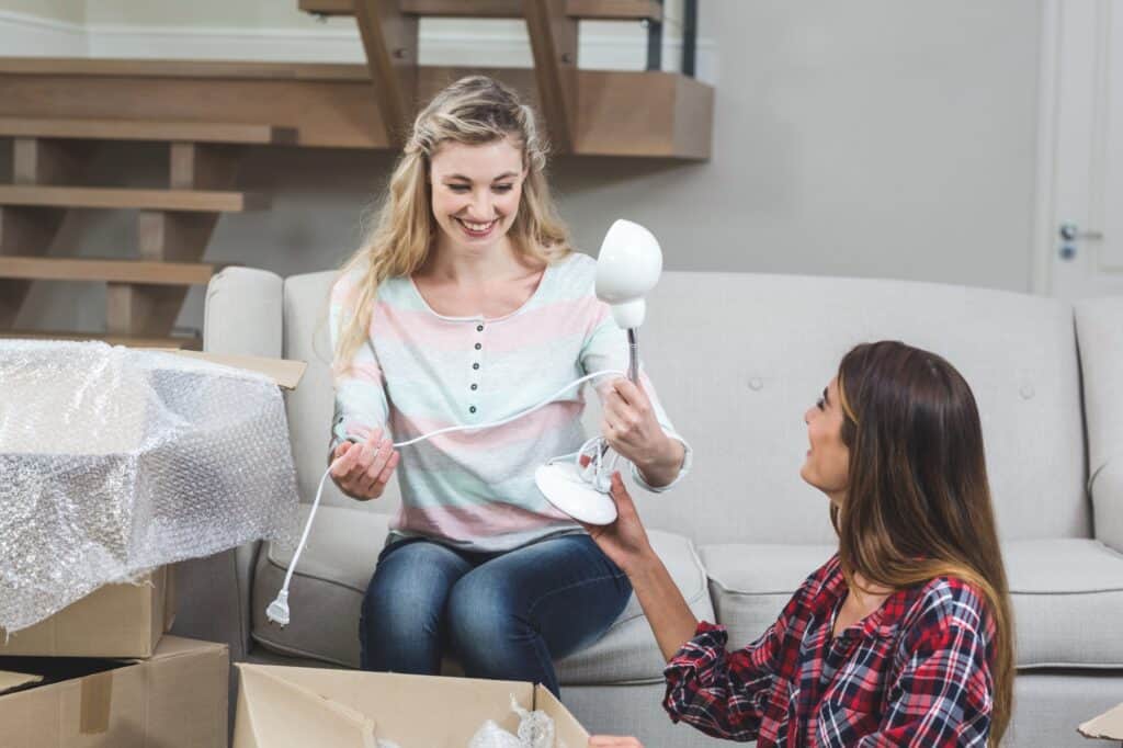 Female friends unpacking in their new house