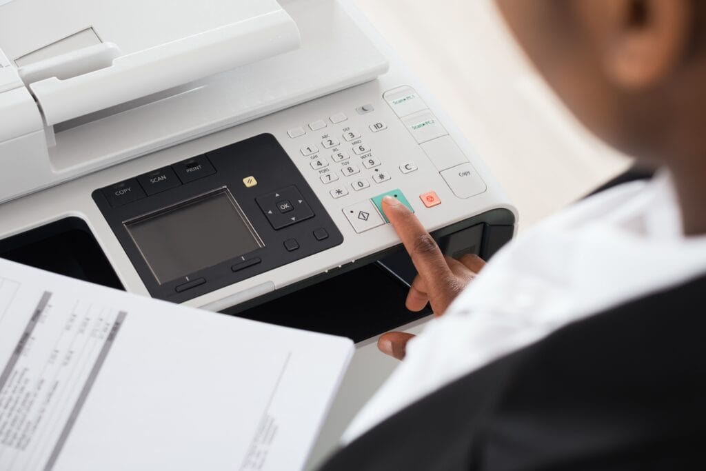 Cropped image of a woman operating an office printer